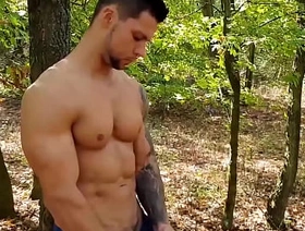 Muscular stud Angelo Godshack wanks off his cock outdoors